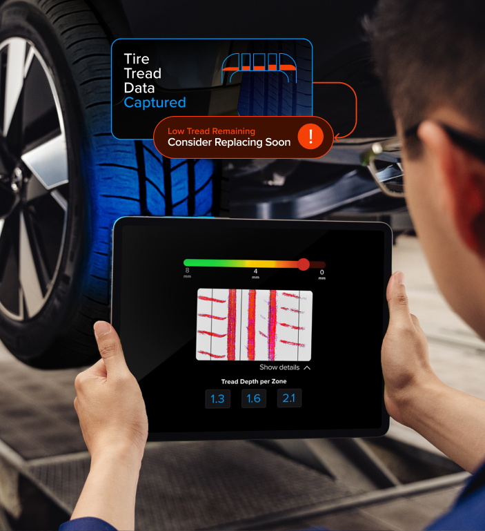 Technician scanning a tire tread with a tablet