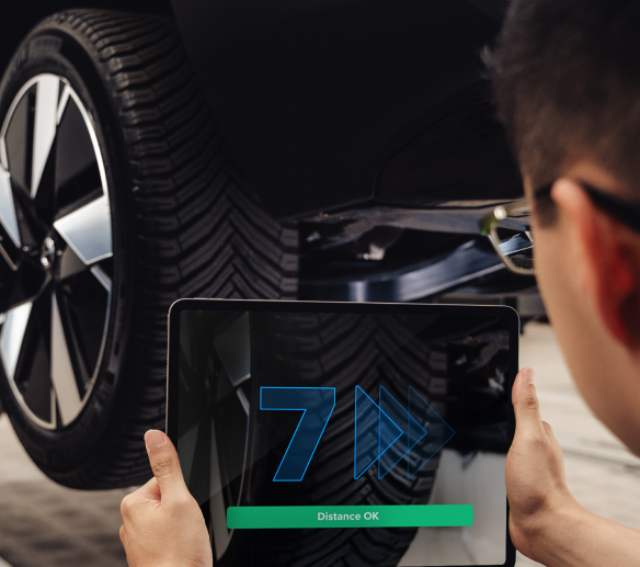 Technician scanning a tire tread with a tablet
